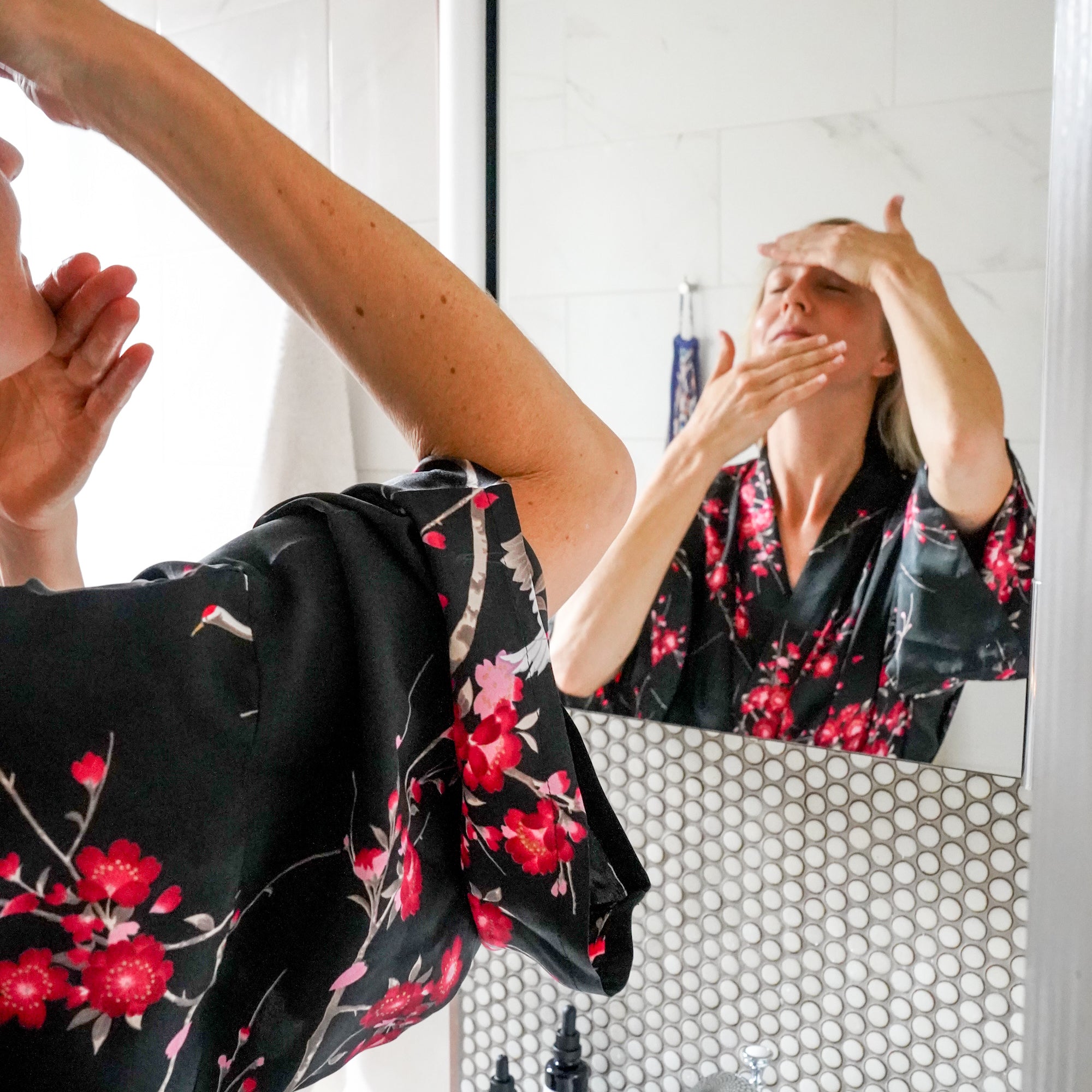 Image of woman applying face oil