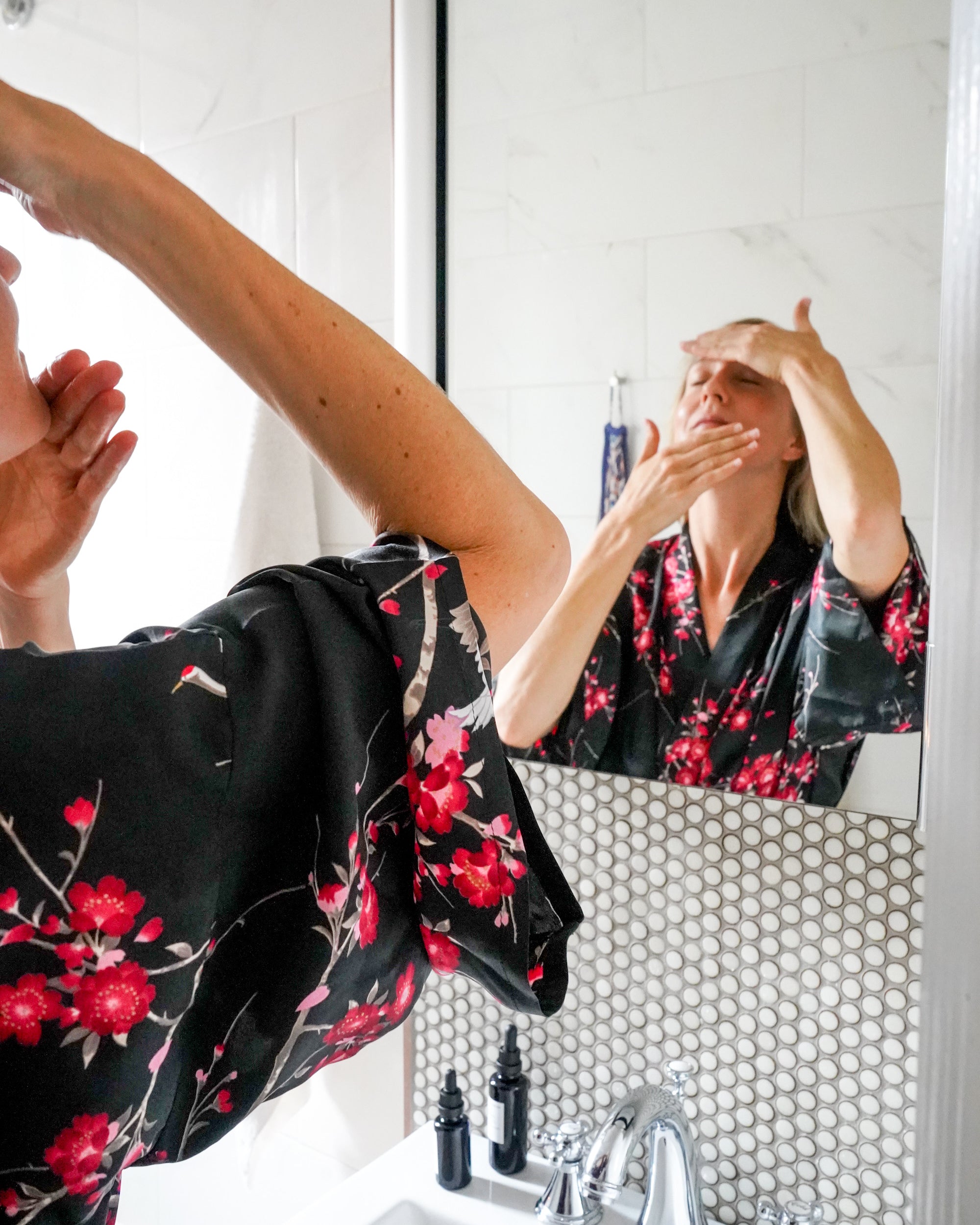 Image of woman applying face oil